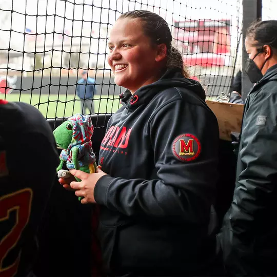 Taylor Liguori with one of softball's stuffed animals in the dugout
