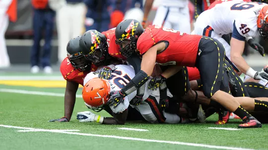 Maryland gang-tackles a Virginia rusher in 2013
