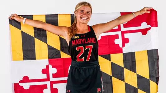 Margot Lawn posing with Maryland flag
