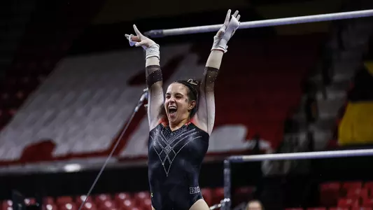 Tasha Brozowski completes her bars routine smiling