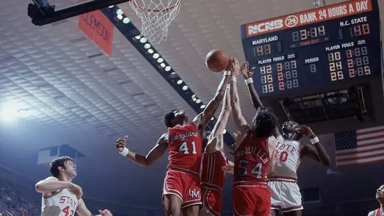 Len Elmore, Tom Roy, and Tom McMillian all go up for a rebound against NC State in the 1974 ACC Championship game.