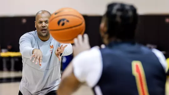 Mike Jones throws the ball to Jahmir Young during a practice
