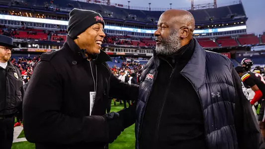 Barry P. Gossett Director of Athletics Damon Evans congratulates Maryland head football coach Michael Locksley following the Terps' win in the 2023 Transperfect Music City Bowl