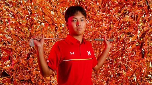 Yang Kuang posed gold background