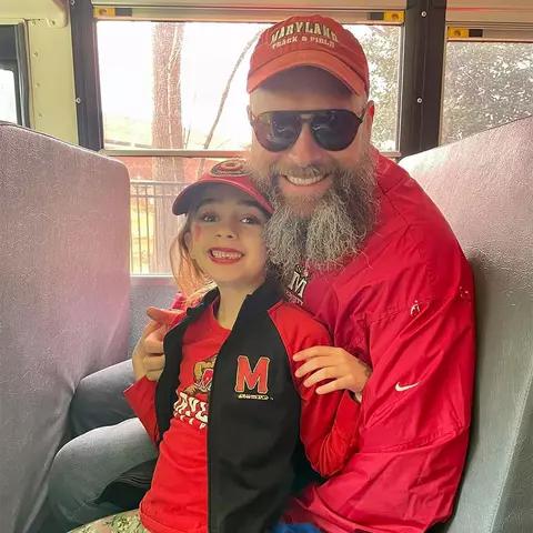 John Collins with his daughter in Maryland gear