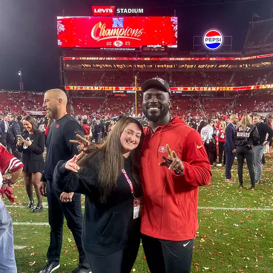Amanda Hilman with Sam Okuayinonu after the 2024 NFC Championship game