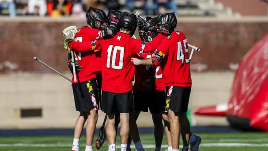 The Terps huddle after a goal in a 12-11 2OT win at Richmond