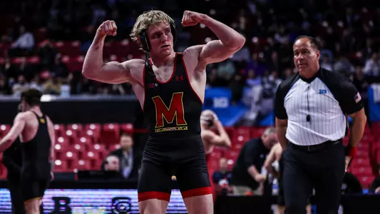 Ethen Miller flexes at the Big Ten Championships