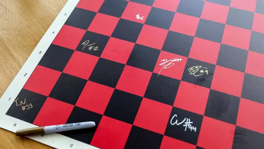 Chess board signed by Maryland's BlitzChamps competitors