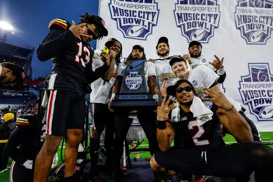 Beau Brade celebrates winning the 2023 Music City Bowl with his teammates