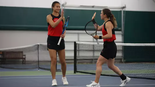 Kallista Liu and Selma Cadar High Five During Doubles Against Minnesota