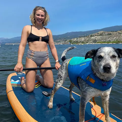 Sarah Faller with her dog, Grady, on a paddle board
