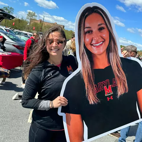 Taylor Hensh holding a cardboard cutout of Victoria Hensh