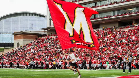M Bar flag at football game