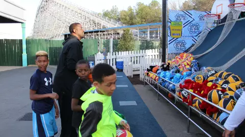 Walt Williams with his sons and Brayden Martin at a carnival game