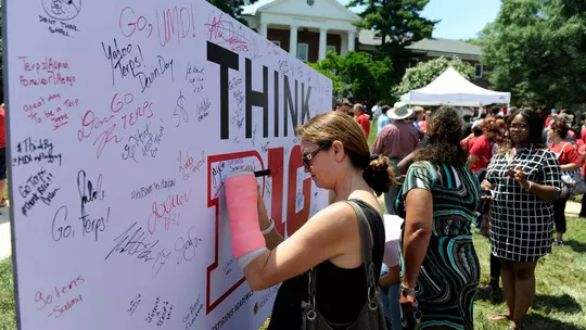 Fans sign the Think B1G board at the B1G Block Party on June 30, 2014