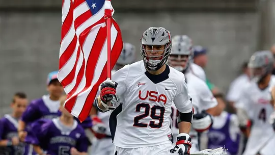 Lee Zink running out the flag as a member of Team USA in 2014