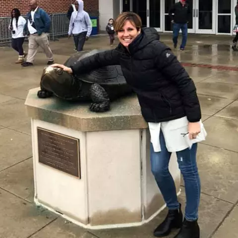 Patty Corson Robbins at XFINITY Center with the Testudo statue
