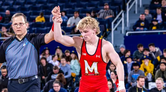 Ethen Miller gets his hand raised after a win against Michigan