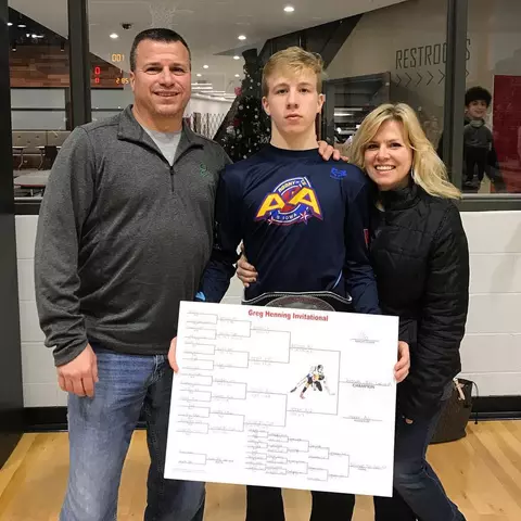 Braxton Brown as a youth wrestler after a tournament with his parents