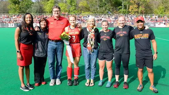 Carrie Hanks with coaches and family on Senior Day in 2017