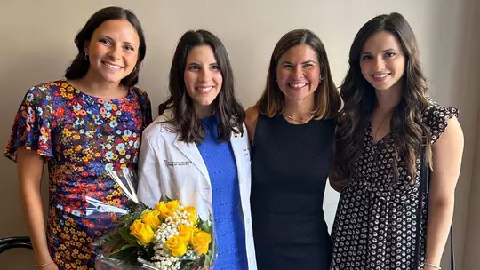 Catie May with her mother and sisters after medical school