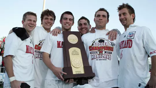 Members of the 2005 Maryland men's soccer team with the NCAA championship trophy