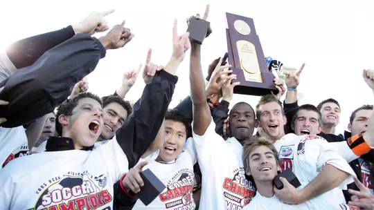 Members of the 2005 Maryland men's soccer team with the NCAA championship trophy