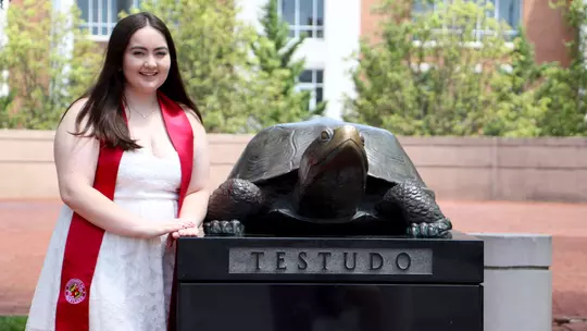 Brooke Martin at the Testudo statue with her graduation sash