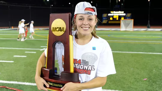 Taylor Cummings holding the NCAA Championship trophy in 2014