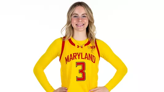 Addi Mack posed gold uniform