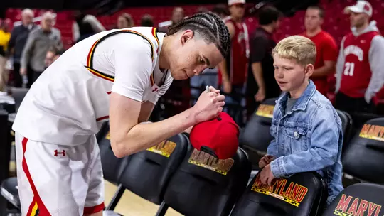 Darius Adams signing an autograph for a young fan