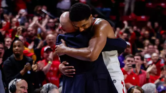 Kevin Willard hugs Julian Reese as he comes out of the game for the final time at XFINITY Center