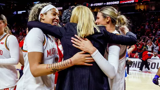 Brenda Frese hugs her student-athletes following Maryland's double overtime win over #5 seed Alabama in the second round of the 2025 NCAA Tournament