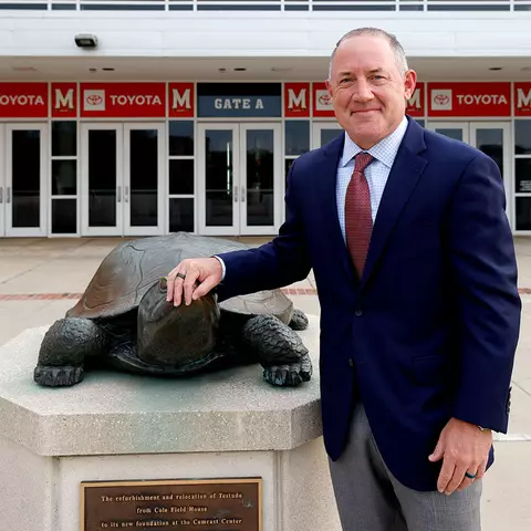 Buzz Williams with the Testudo statue