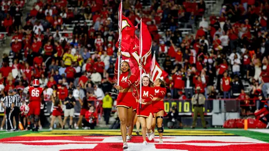 Cheerleaders flag on football field