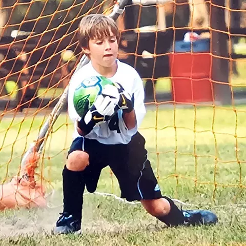 Logan McNaney playing soccer in his youth
