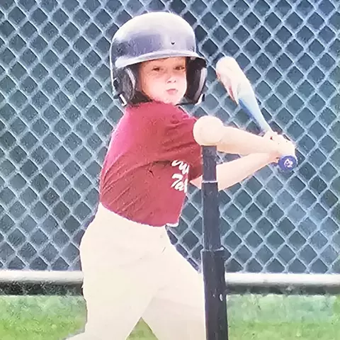 Logan McNaney playing tee ball in his youth