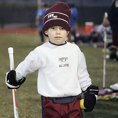 Logan McNaney as a youth with a lacrosse stick