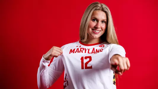 Katie Scherer red backdrop posed