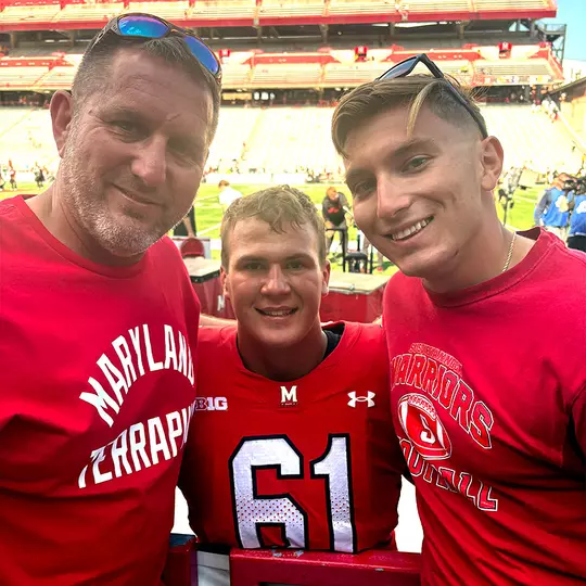 Michael Hershey with high school wrestling coach after a Maryland football game