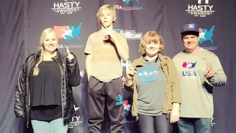 Carter Young as a youth at a wrestling tournament with his family