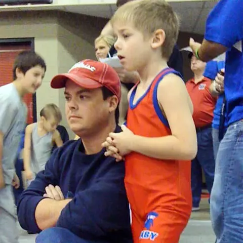 Carter Young as a youth at a wrestling tournament with his father