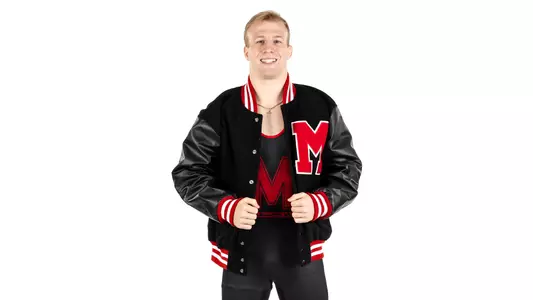 Braxton Brown poses against white backdrop in a varsity Jacket