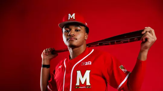 Posed photo of Paul Jones II with a bat across his shoulders