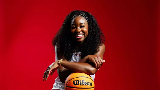 Studio photo of Mir McLean holding a basketball
