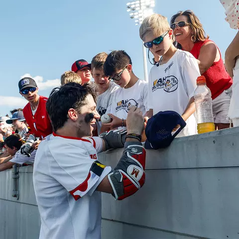 Eric Spanos signing autographs for young fans after the 2025 NCAA Semifinal win over Syracuse