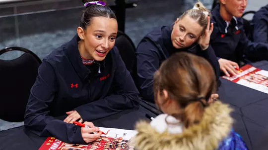 Gianna Ruffing signing an autograph for a young fan at XFINITY Center