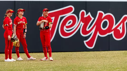 Outfielders standing in a group in outfield