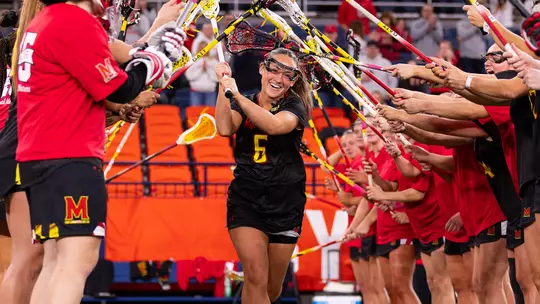 Keeley Block running through the tunnel of teammates prior to the game at Syracuse